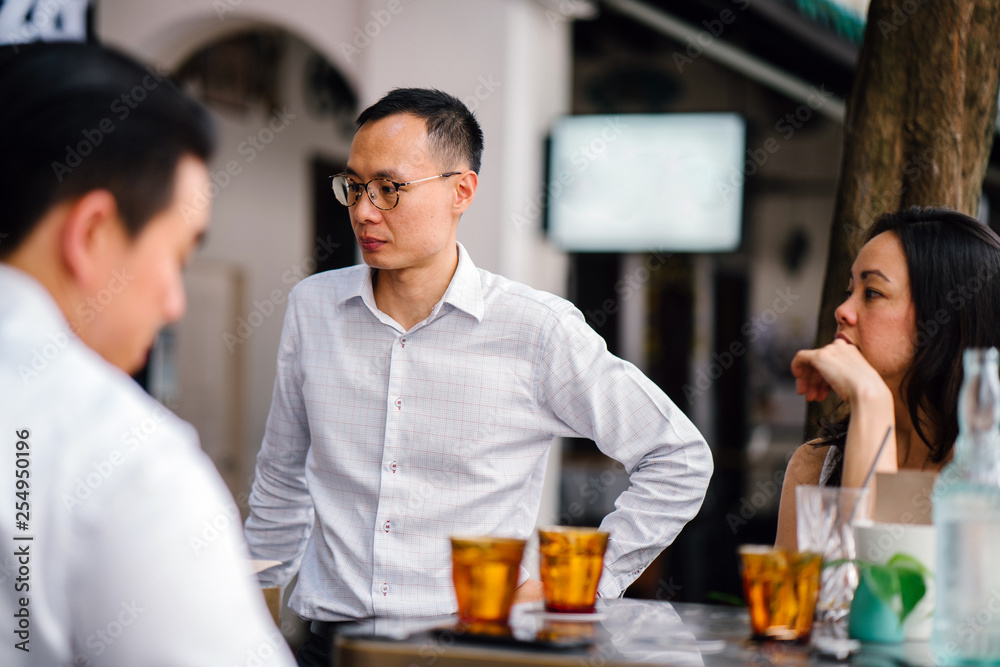 Image of a diverse team having their cocktail drink outdoors while enjoying each others company. They are all dressed professionally and competently. Image of a diverse team having their cocktail drink outdoors while enjoying each others company. They are all dressed professionally and competently.