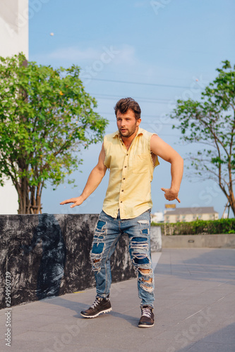 Young man dancing breakdance on the street. photo