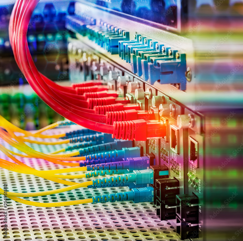 Fiber Optic cables connected to an optic ports and Network cables ...