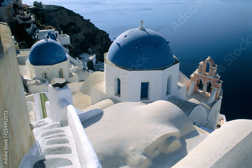 Dwellings step down the cliffside to the Sea of The Caldera, Oia, Santorini, Greece