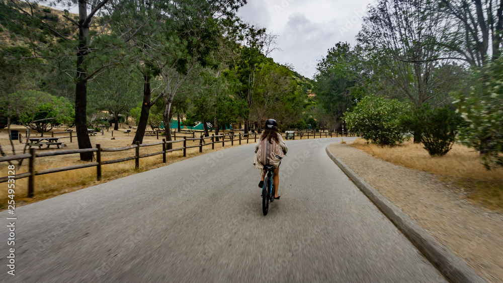 girl rides electric bicycle on Catalina island girl rides electric bicycle on Catalina island