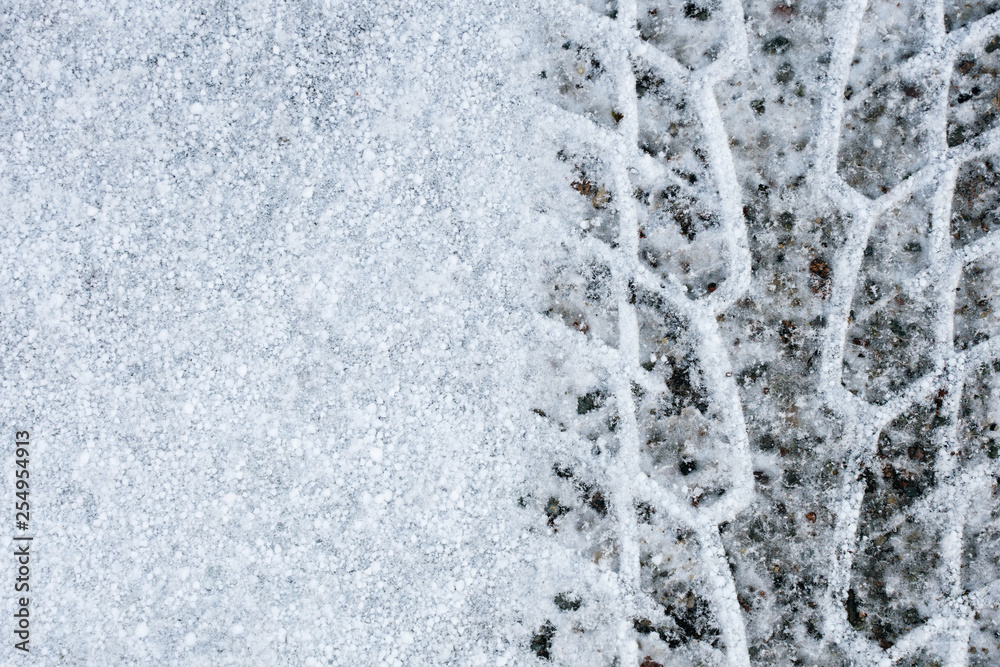 Fototapeta premium Imprint wheel tread on the snow. Weather forecast. Cooling.