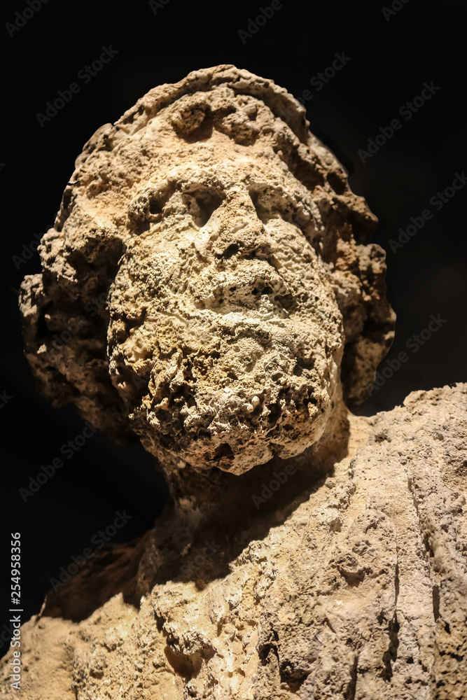 Really eroded head of Poseidon - god of the sea earthquakes storms, and horses - that was underwater for a long time and is pitted and worn Really eroded head of Poseidon - god of the sea earthquakes storms, and horses - that was underwater for a long time and is pitted and worn