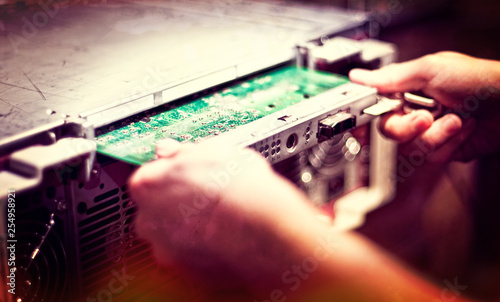 Man inserting a Controller Card into a Server