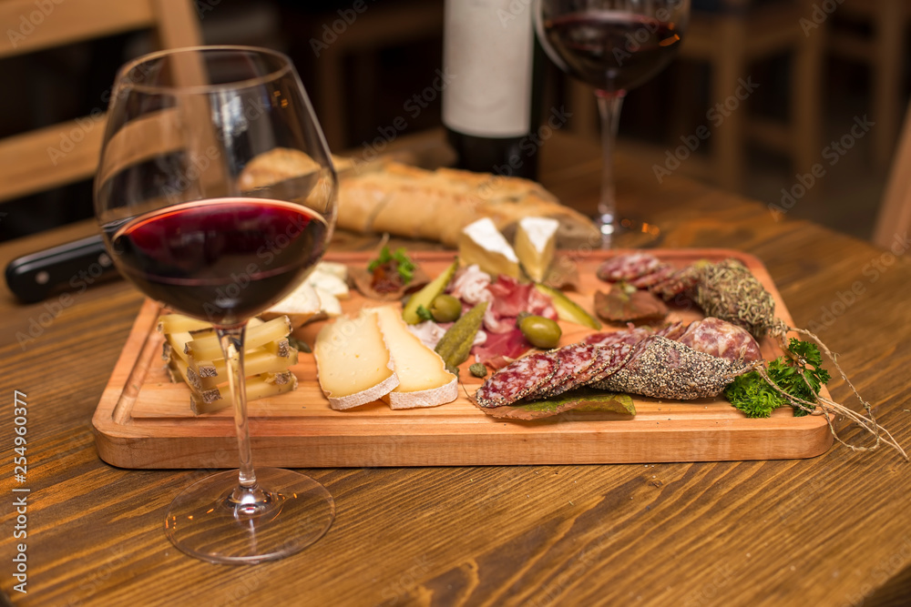 Cheese, sausages and red wine as an appetizer Cheese, sausages and red wine as an appetizer
