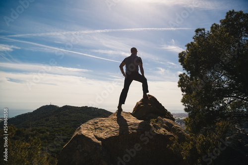 Back view of hiker on top of mountain enjoying the view