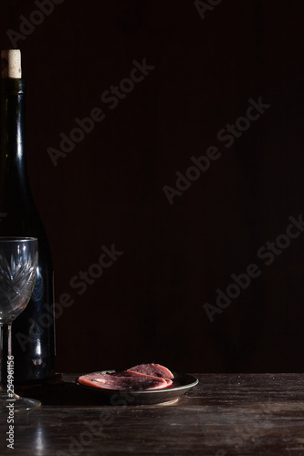 Wine bottle with wineglass in black background. Vector