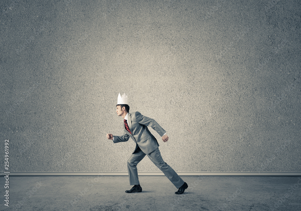 King businessman in elegant suit running in empty room King businessman in elegant suit running in empty room