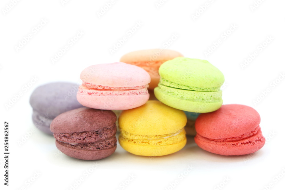Close up many colorful fresh macarons pile isolated on white background, look delicious Close up many colorful fresh macarons pile isolated on white background, look delicious