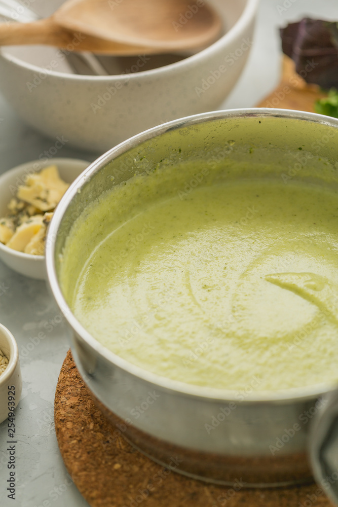 Fresh made broccoli cream soup in cooking pan. selective focus Fresh made broccoli cream soup in cooking pan. selective focus