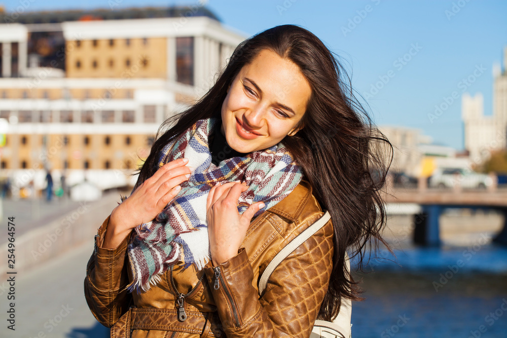 Young happy woman in brown leather jacket