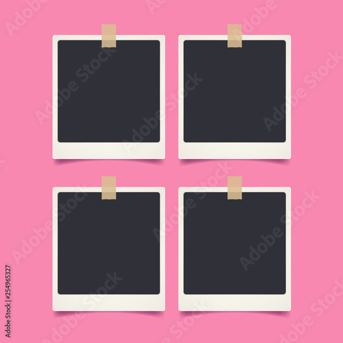 Realistic vintage blank photo sticked using washi tape on pink background.