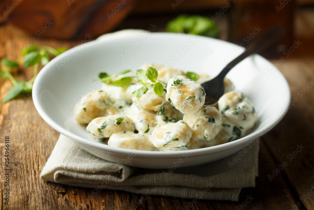 Homemade potato gnocchi with creamy basil sauce Homemade potato gnocchi with creamy basil sauce