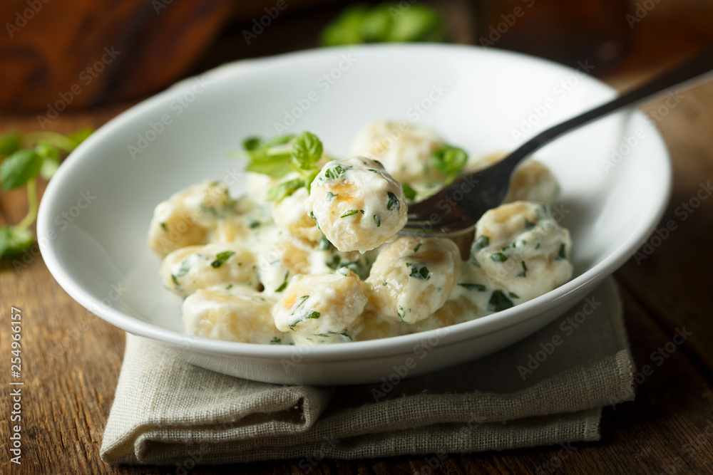 Homemade potato gnocchi with creamy basil sauce Homemade potato gnocchi with creamy basil sauce
