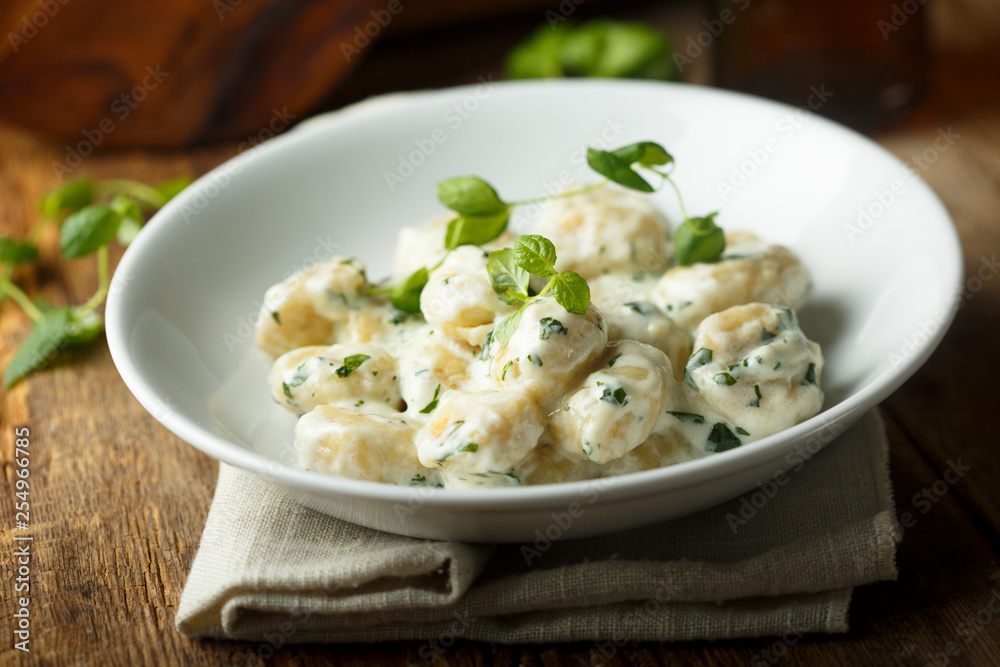 Homemade potato gnocchi with creamy basil sauce Homemade potato gnocchi with creamy basil sauce