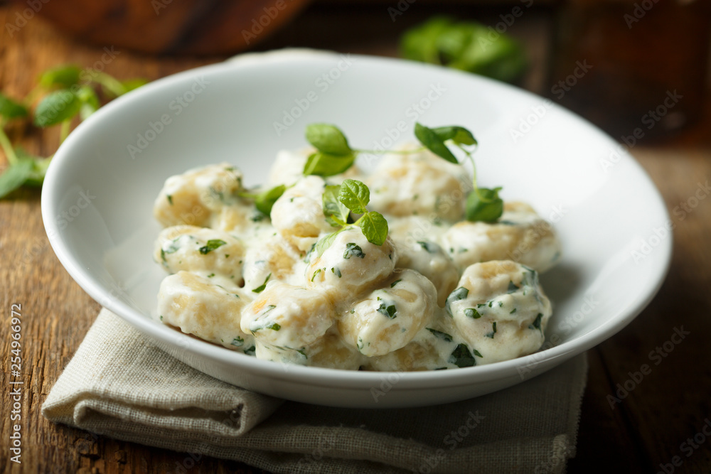 Homemade potato gnocchi with creamy basil sauce Homemade potato gnocchi with creamy basil sauce