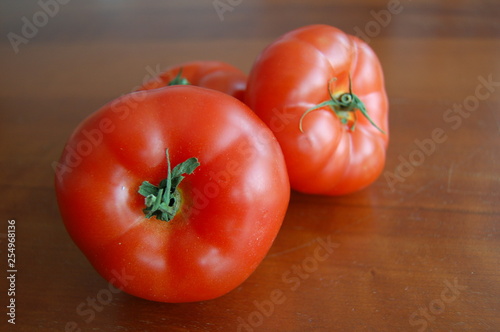 fresh tomatoes on wooden table