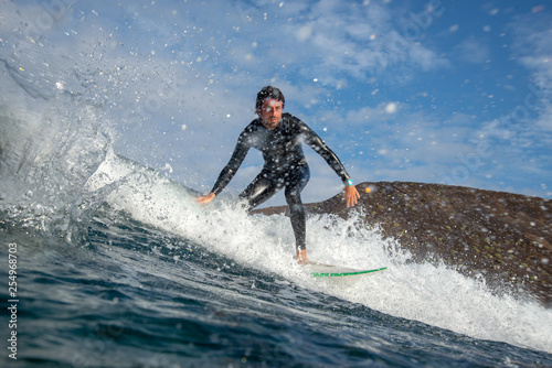 surfer riding waves on the island of fuerteventura in the Atlantic Ocean