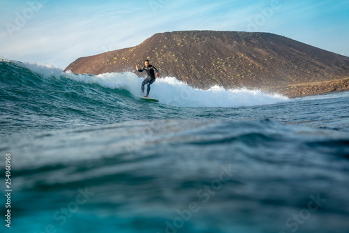 surfer riding waves on the island of fuerteventura in the Atlantic Ocean