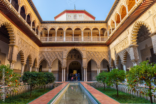 Seville / Spain: Tourists in the yard of Real Alcazar Royal Palace - March 2019