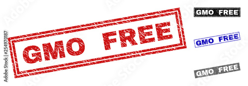 Grunge GMO FREE rectangle stamp seals isolated on a white background. Rectangular seals with grunge texture in red, blue, black and grey colors.