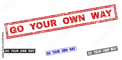Grunge GO YOUR OWN WAY rectangle stamp seals isolated on a white background. Rectangular seals with grunge texture in red, blue, black and grey colors.