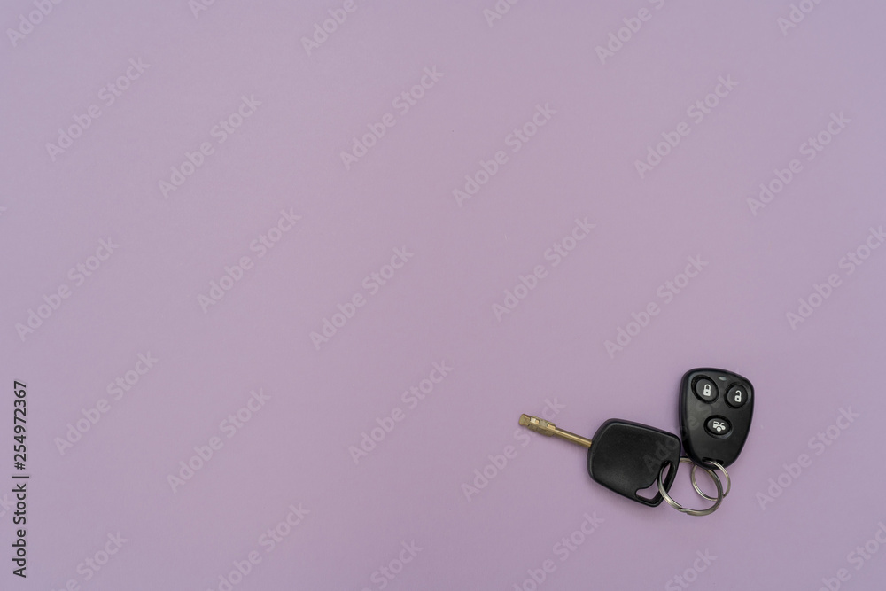 Auto key and remote above on the right on purple background. Success in business. Car owner