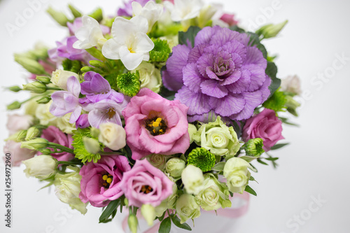 Wonderful flower arrangement  white  lilac  pink  light green color  in a white hat box on a light background