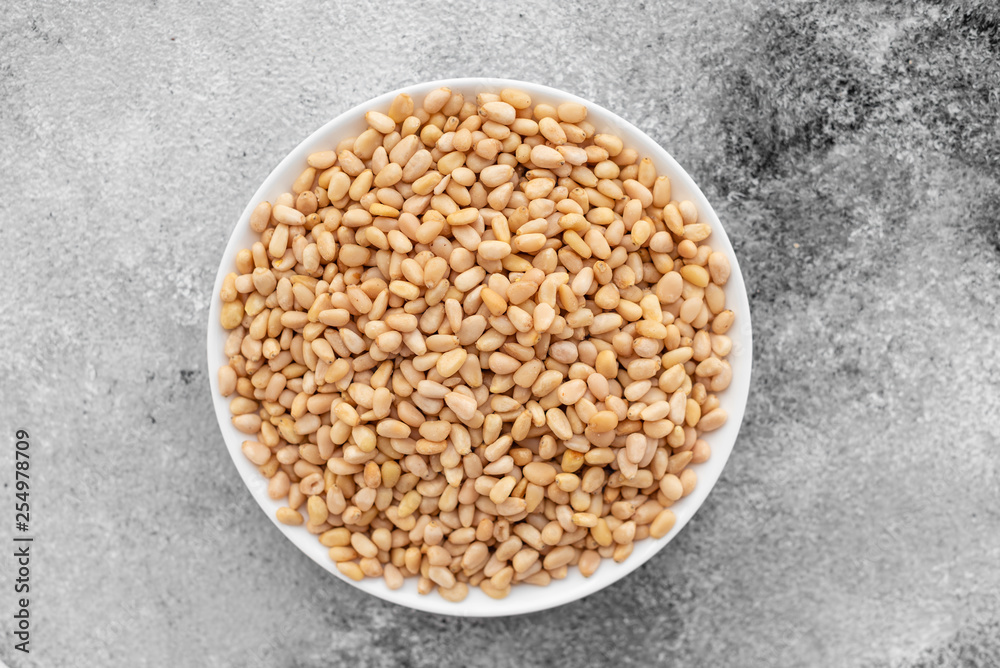 Pine nuts close up. Breakfast, healthy food. It can be used as a background Pine nuts close up. Breakfast, healthy food. It can be used as a background