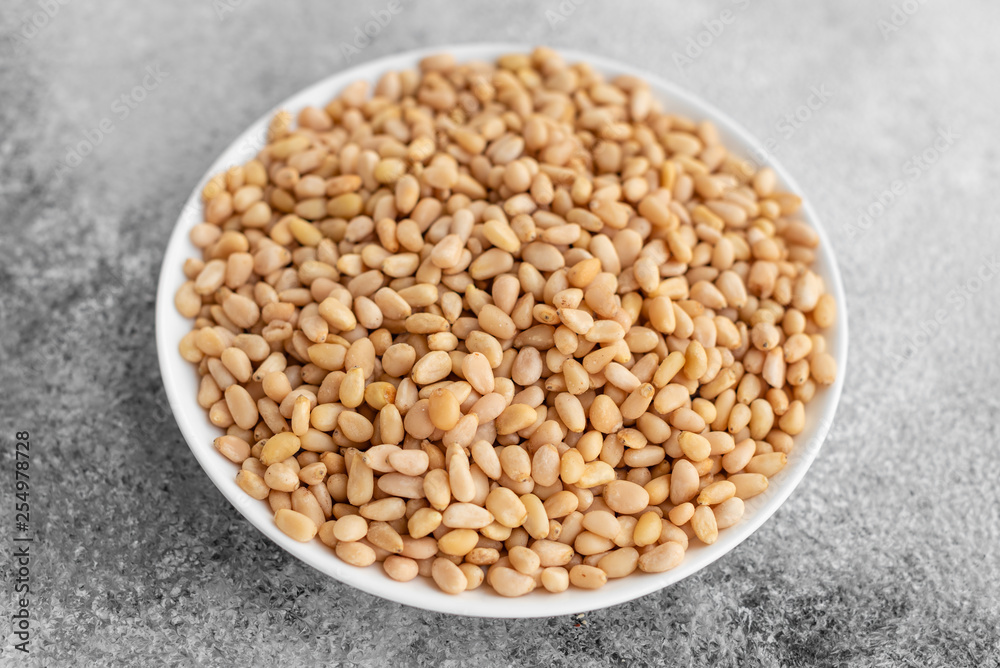 Pine nuts close up. Breakfast, healthy food. It can be used as a background Pine nuts close up. Breakfast, healthy food. It can be used as a background