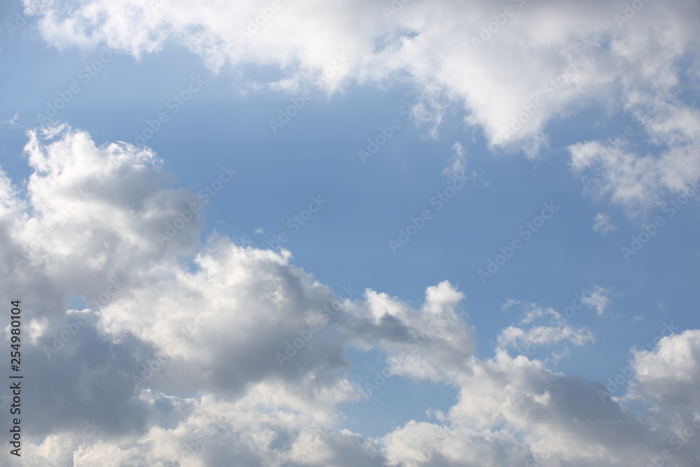 Fototapeta premium Clear blue sky with cumulus and cirrus clouds. Sunny weather. Joyful mood. High pressure. Clean air ecology. Water in a gaseous state. The source of rain and hail. Weather prediction.Clear blue sky