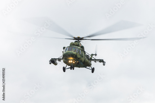 Fototapeta Naklejka Na Ścianę i Meble -  Military helicopter flying against the cloudy sky