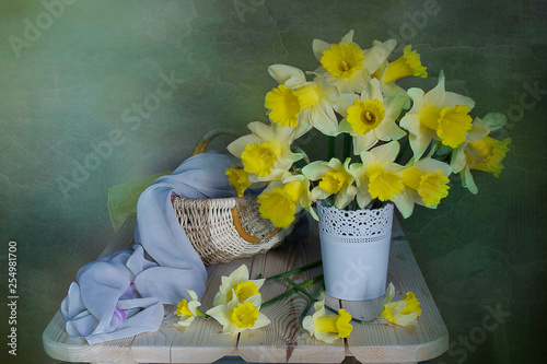 A large bouquet of daffodils in a vase on a colorful backgro