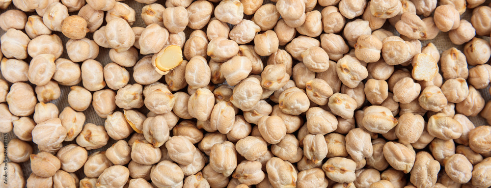 Dry chickpeas uncooked full background, banner, top view Dry chickpeas uncooked full background, banner, top view