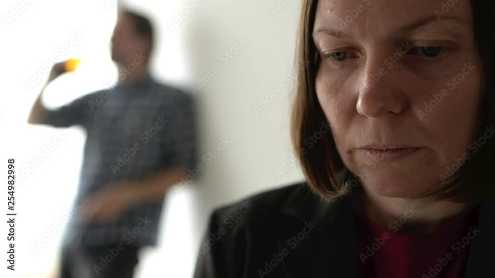 Drunk man drinking beer and arguing with his wife at home, adult caucasian couple in domestic dispute concept yelling at each other. Drunk man drinking beer and arguing with his wife at home, adult caucasian couple in domestic dispute concept yelling at each other.