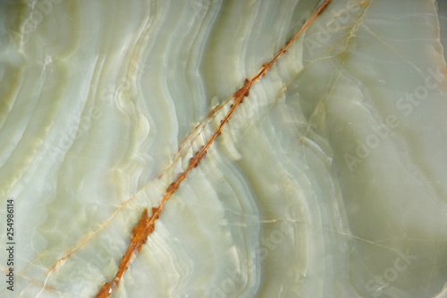 Natural green onyx stone with a red stripe on the surface