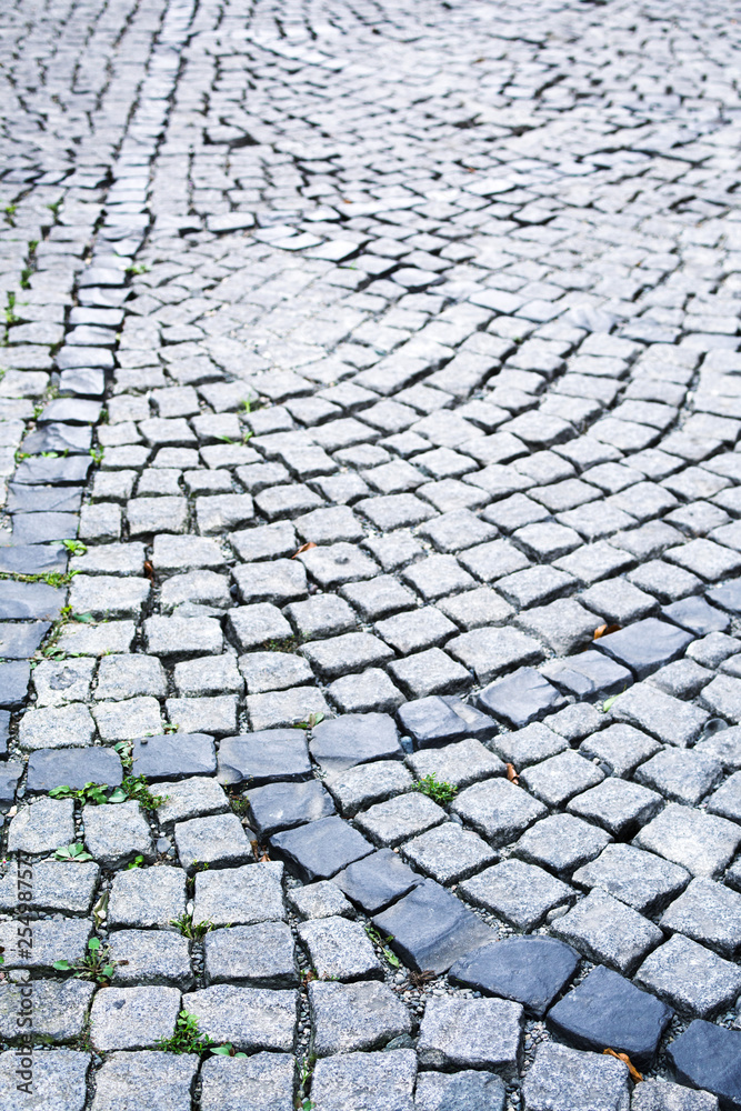 Fototapeta premium Stone pavement in the old town. Road lined with decorative gray stone, pavement