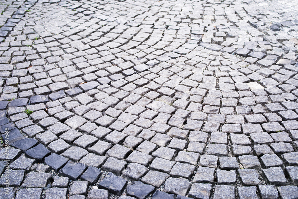 Stone pavement in the old town. Road lined with decorative gray stone, pavement