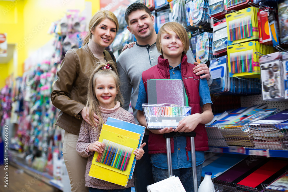 Parents and children buying writing materials