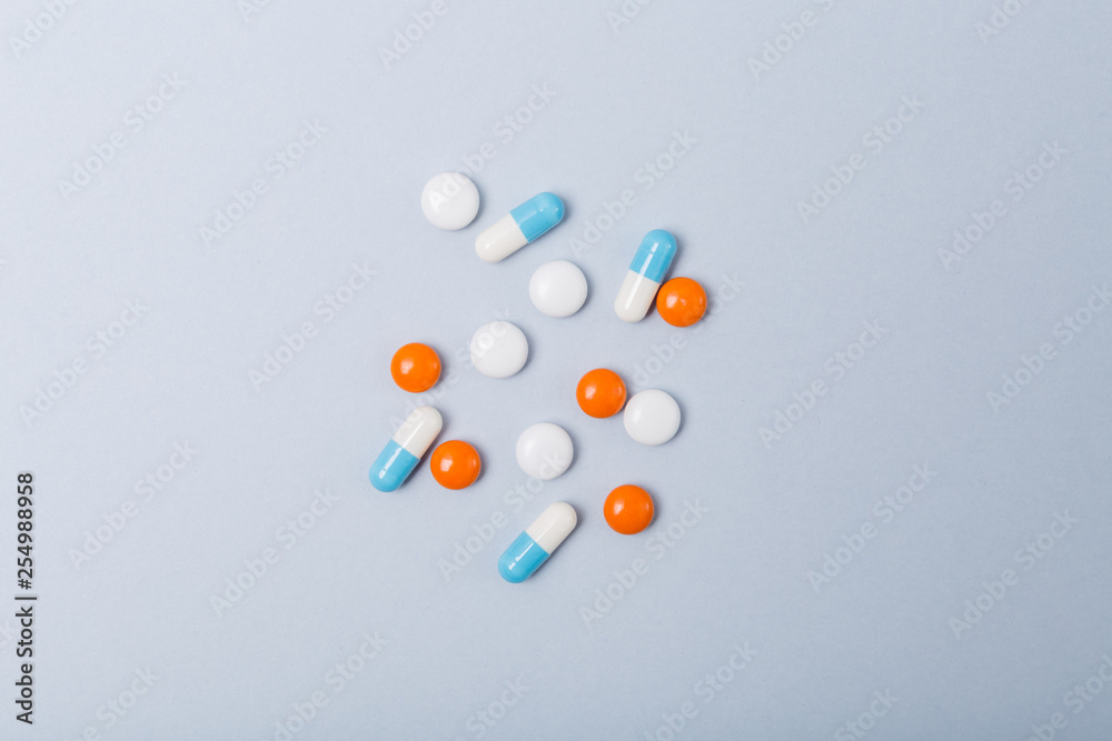 Assorted pharmaceutical medicine pills, tablets and capsules over blue background. Copy space. Medicine medical concept. Be healthy. Assorted pharmaceutical medicine pills, tablets and capsules over blue background. Copy space. Medicine medical concept. Be healthy.