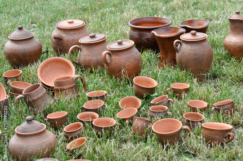 Lots of traditional ukrainian handmade clay pottery production on the green grass © beerfan