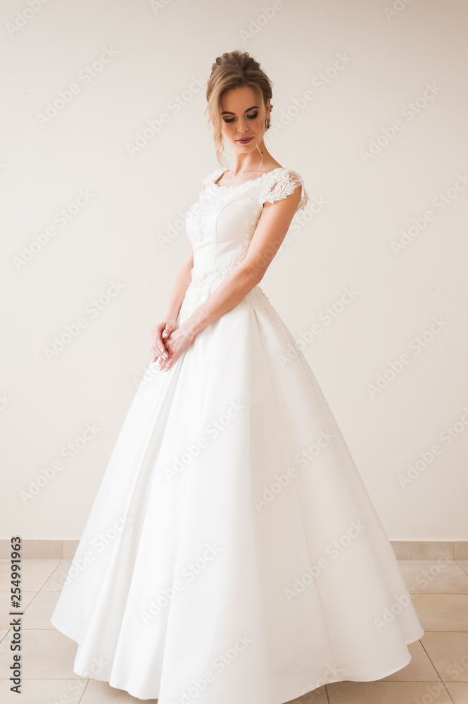 Fashion bride in gorgeous wedding dress studio portrait. Beautiful model with bridal makeup and hairstyle in marriage lace dress. Fashion bride in gorgeous wedding dress studio portrait. Beautiful model with bridal makeup and hairstyle in marriage lace dress.