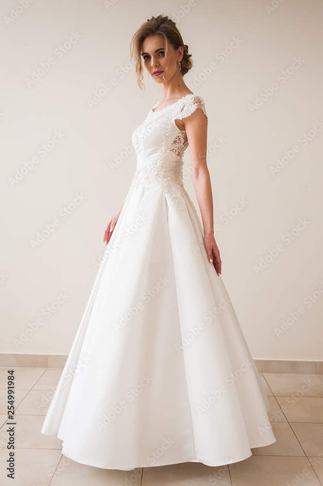 Fashion bride in gorgeous wedding dress studio portrait. Beautiful model with bridal makeup and hairstyle in marriage lace dress. Fashion bride in gorgeous wedding dress studio portrait. Beautiful model with bridal makeup and hairstyle in marriage lace dress.