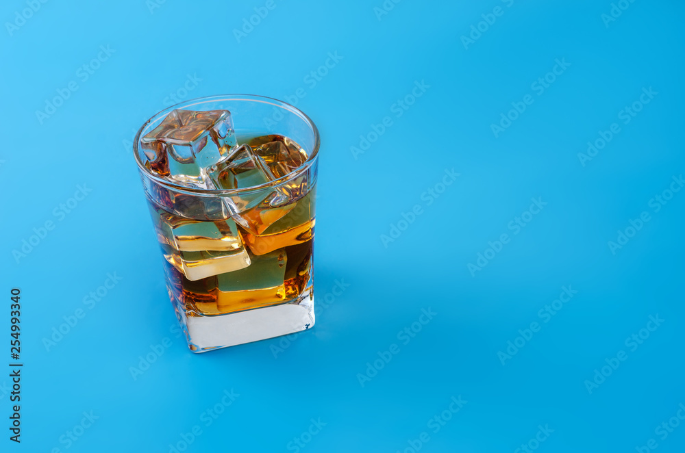 Alcohol in a glass with pastel blue background Alcohol in a glass with pastel blue background