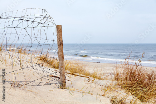 Fence on a beach dune, selective focus.