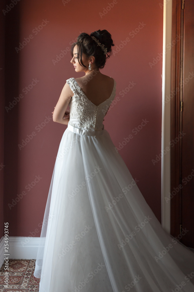 Portrait of a beautiful bride woman in elegant white wedding dress. Luxurious apartments. Portrait of a beautiful bride woman in elegant white wedding dress. Luxurious apartments.