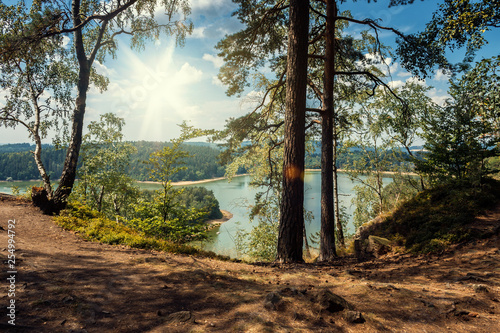 Seč - Sec Dam with Path in Forest. Czech Republic, Bohemia, Europe. Summer Landscape with Sun on Blue Sky and Water in Lake. Nature Scene.