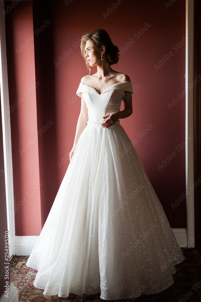 Portrait of a beautiful bride woman in elegant white wedding dress. Luxurious apartments. Portrait of a beautiful bride woman in elegant white wedding dress. Luxurious apartments.