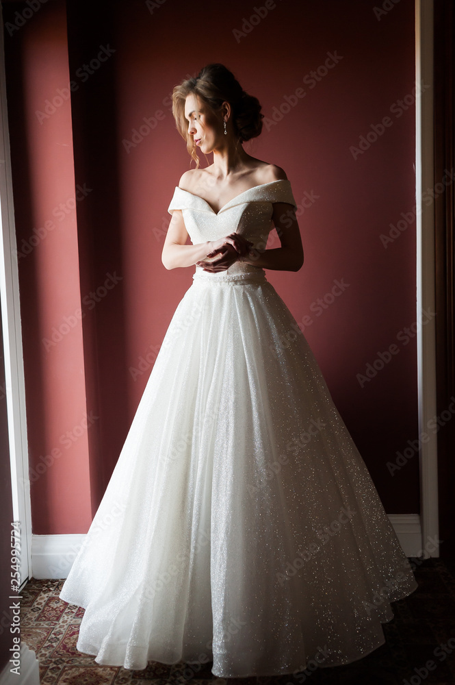 Portrait of a beautiful bride woman in elegant white wedding dress. Luxurious apartments. Portrait of a beautiful bride woman in elegant white wedding dress. Luxurious apartments.