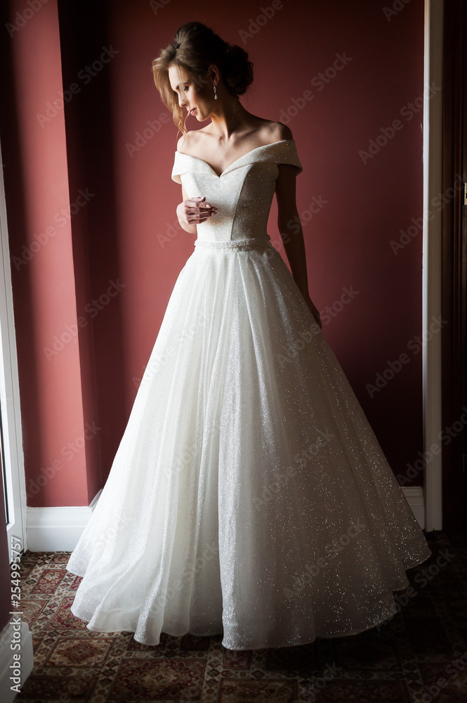 Portrait of a beautiful bride woman in elegant white wedding dress. Luxurious apartments. Portrait of a beautiful bride woman in elegant white wedding dress. Luxurious apartments.